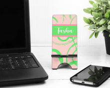 Load image into Gallery viewer, Pink and Green Abstract Cell Phone Stand. Custom Phone Stand, Fits most Cell phones. Great Sorority gift. Perfect for desks, night stands!